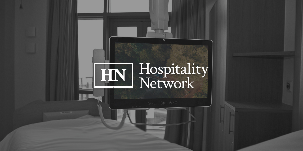 Hospital room with a TV Screen and the Hospitality Network's Logo